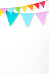 Colorful party flags hanging on white wall  background, birthday, anniversary, celebrate event, festival greeting card background
