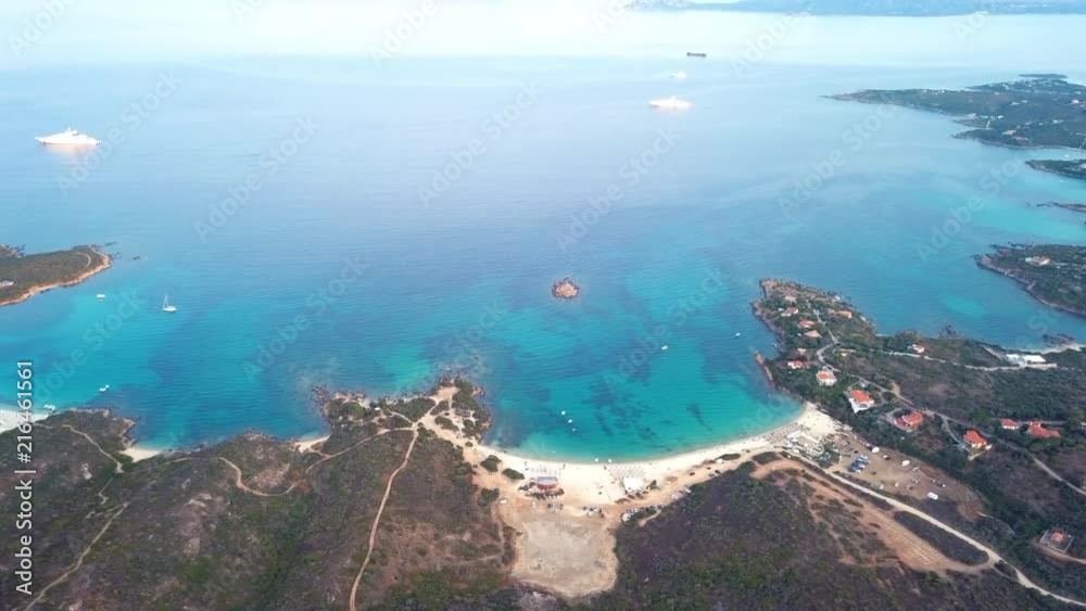 Video from above, aerial view of an amazing beach with a turquoise and trasparente sea. Tavolara island on background, Sardinia, Italy. Video from above, aerial view of an amazing beach with a turquoise and trasparente sea. Tavolara island on background, Sardinia, Italy.