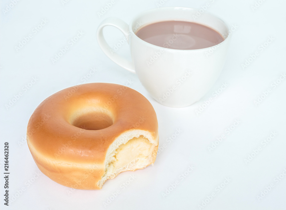 Bite marks on donuts and cup cocoa drink on white background Bite marks on donuts and cup cocoa drink on white background