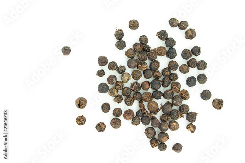 black peppercorns heap top view on white background.