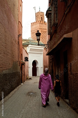 Принти на полотні Marrakesh / Morocco - JUN 20 2014: mother walking home with her kid in front of
