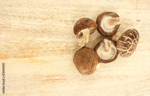 mushrooms top view on wooden background.