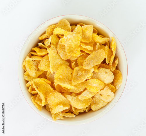 corn flakes on white bowl on white background.