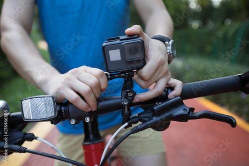 Cyclist mounting the action camera on mountain bike