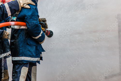 Firefighters training ,firefighters spray water to fire