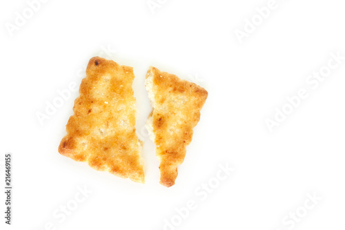 Crackers broken in half on white background.