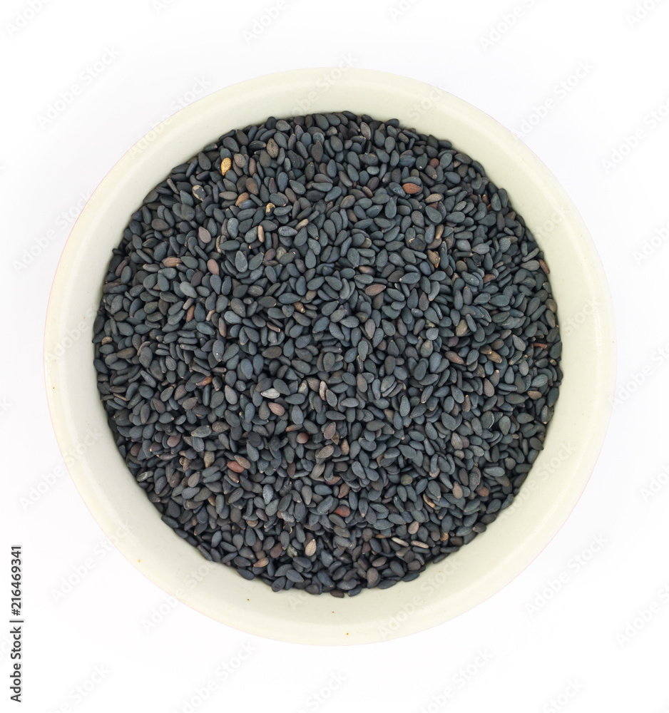 Black sesame in white bowl on white background top view. Black sesame in white bowl on white background top view.