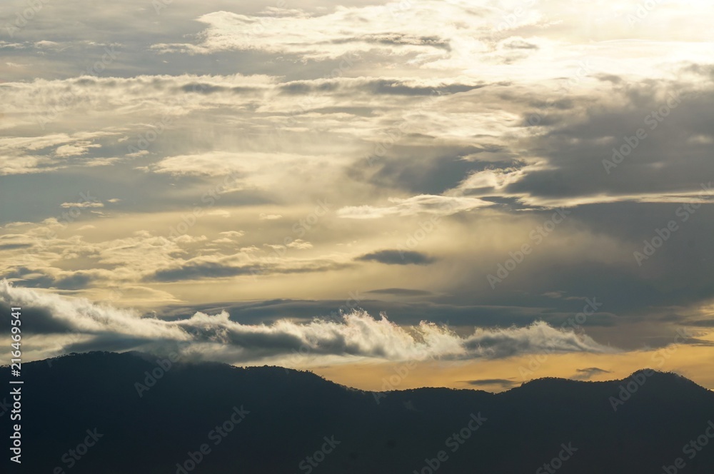 Dramatic cloud, mist, and sun beam when sunrise. 