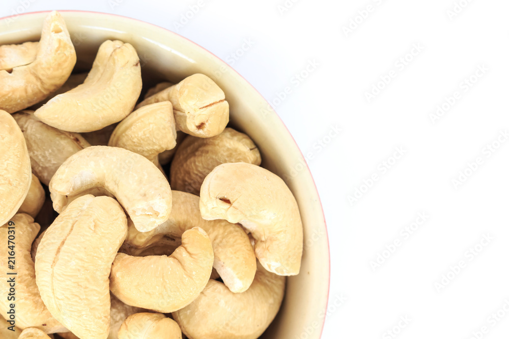 cashew in white bowl top view on white background. cashew in white bowl top view on white background.