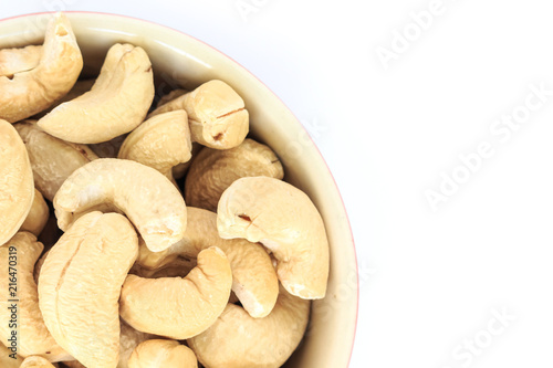 cashew in white bowl top view on white background.