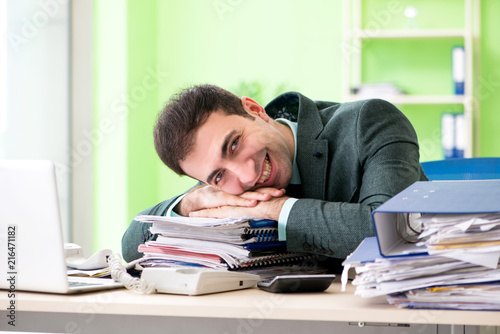 Businessman angry with excessive work sitting in the office