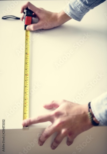 Man measuring the cabinet