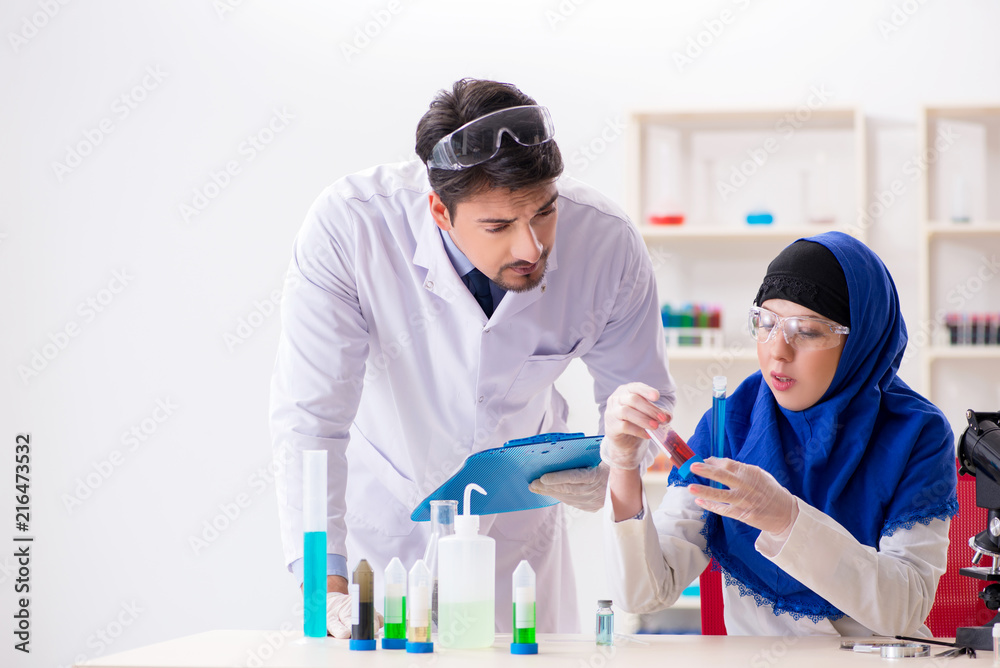 Two chemists working in the lab Two chemists working in the lab
