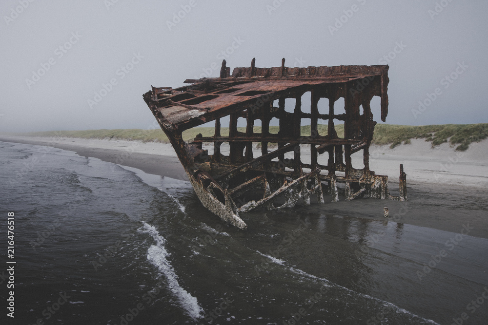 Old boat wreck on the coast Stock Photo | Adobe Stock