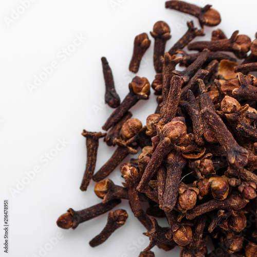 fragrant cloves on a white acrylic background