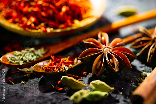 Spices. Various Indian spices on black stone table. Spice and herbs on slate background. Cooking ingredients