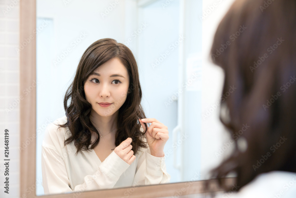 Obraz premium 鏡を見る女性