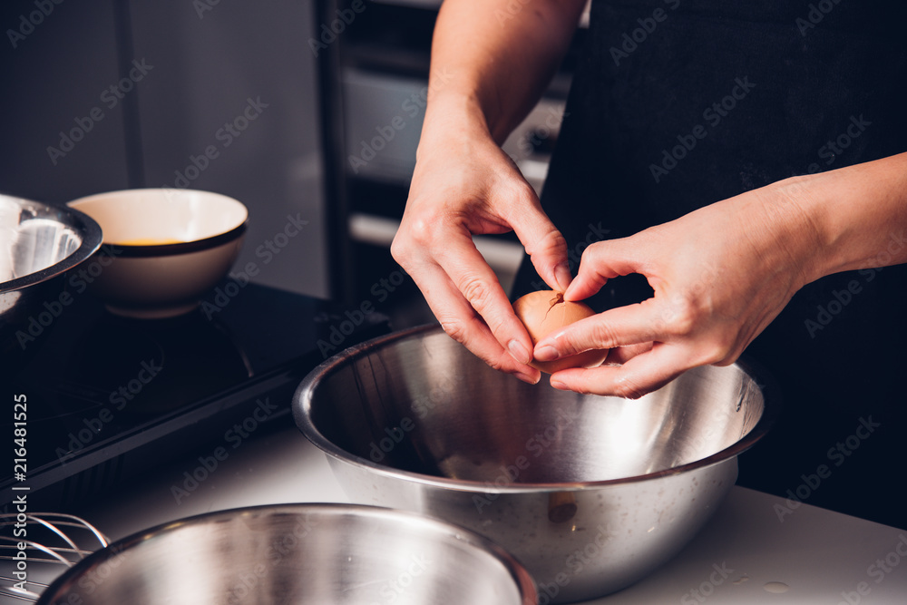 Woman girl baker in kitchen cooking whisk egg Woman girl baker in kitchen cooking whisk egg