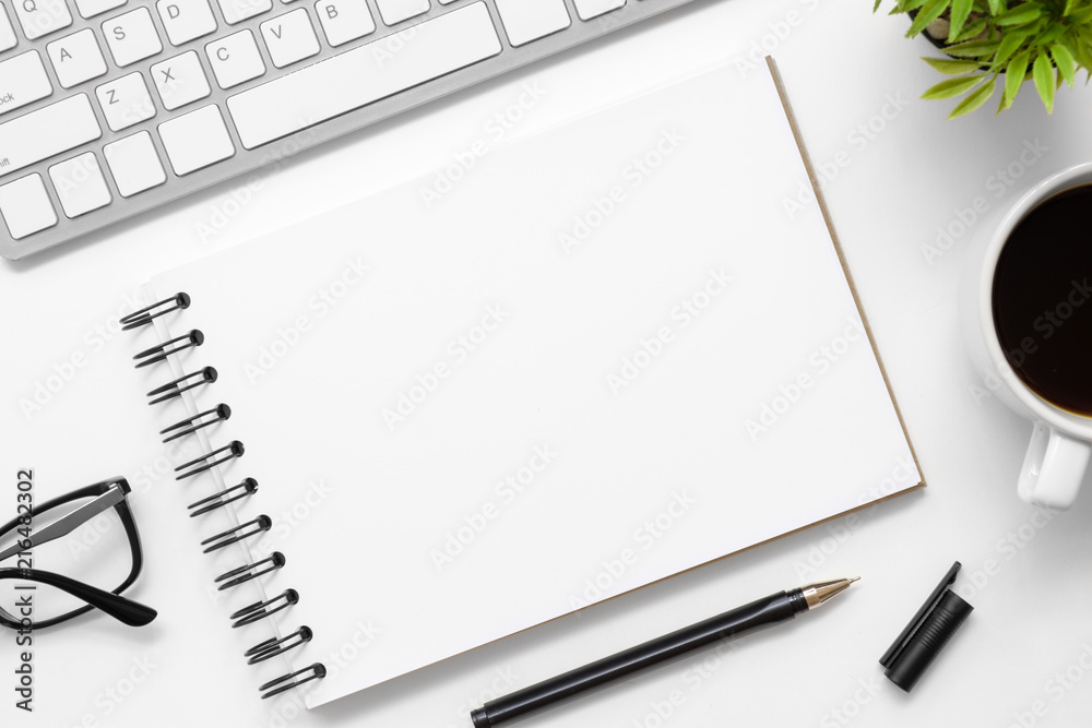 Blank notebook is on top of modern white office desk table with supplies. Top view with copy space, flat lay. Blank notebook is on top of modern white office desk table with supplies. Top view with copy space, flat lay.