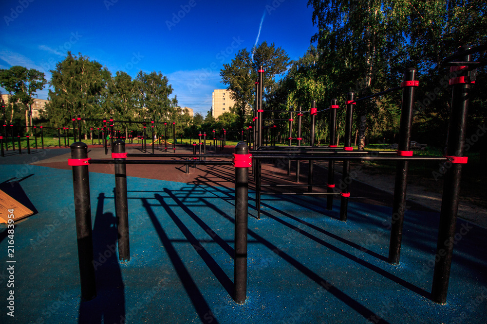 Empty street workout place in summer morning. City sport recreation with coating of rubber chips. Healthy lifestyle concept.