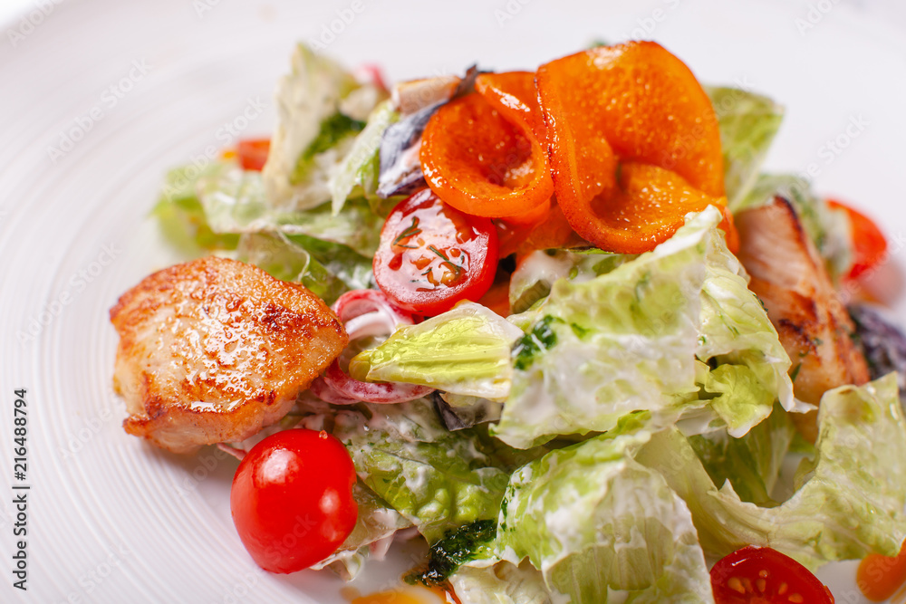 Bowl of salad with duck, orange and vegetables. Asian food. Salad on a white dish on table. restaurant menu Bowl of salad with duck, orange and vegetables. Asian food. Salad on a white dish on table. restaurant menu