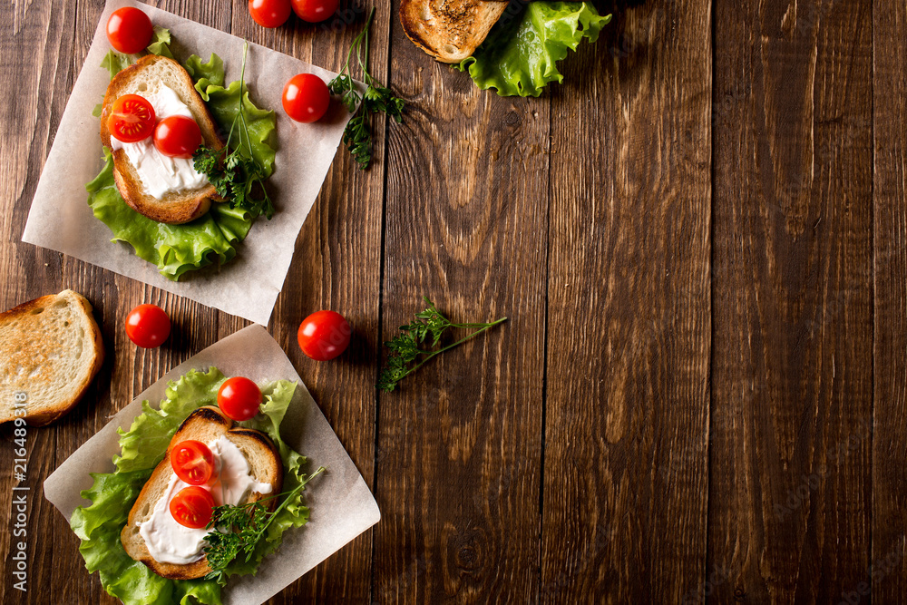Homemade Burger with tomatoes and lettuce. Fast food. Homemade Burger with tomatoes and lettuce. Fast food.
