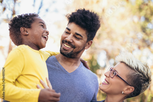 Happy young mixed race couple spending time with their daughter having fun