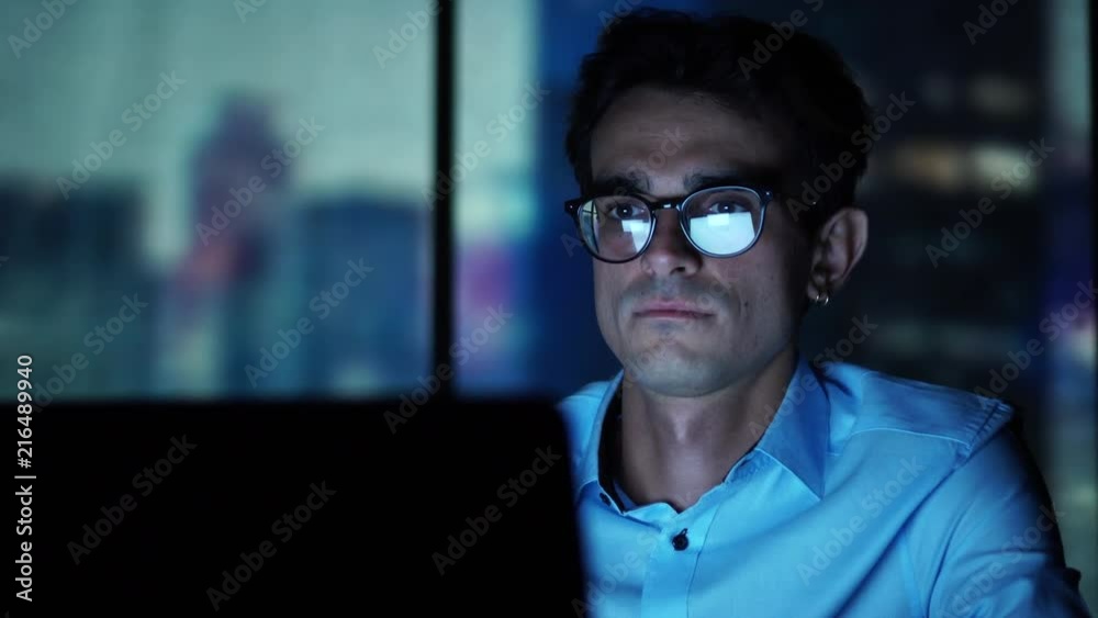 Young Executive Manager Looking at Laptop Screen at Workplace, Working in the Office Young Executive Manager Looking at Laptop Screen at Workplace, Working in the Office