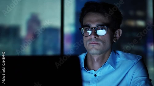 Young Executive Manager Looking at Laptop Screen at Workplace, Working in the Office