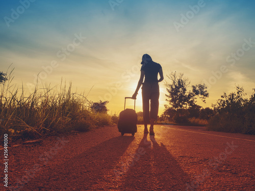 Traveling girls are traveling with luggage. Through nature tourism. (Travel ideas)
