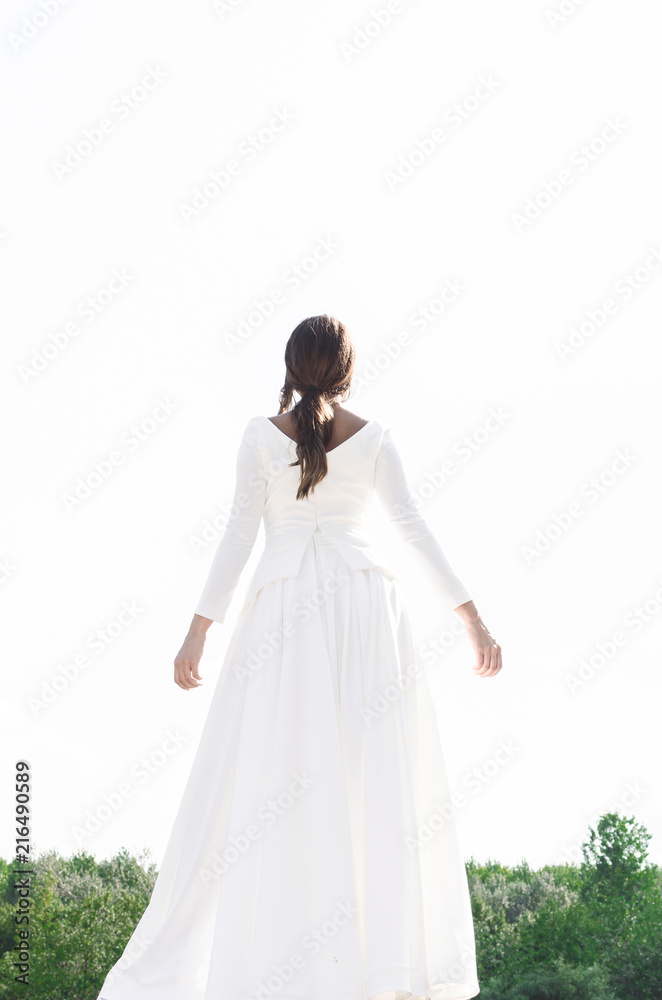 Girl posing in nature in long white dress Girl posing in nature in long white dress