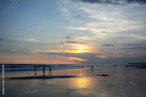 people on tropical beach at sunset © DSGNSR