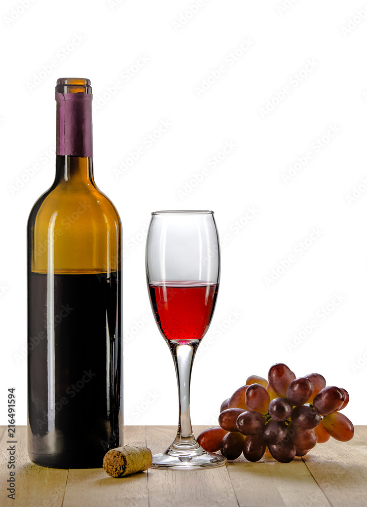 Glass of wine with grape on wooden background.