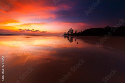Sunrise with beautiful reflection. silhouette of unknown people appear on the image. 
