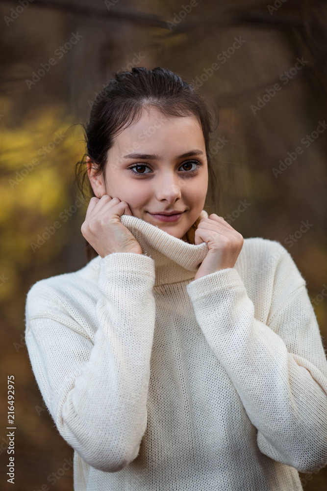 Portrait of beautiful tennage girl standing and posing in autumn park or forest. Natural light. Portrait of beautiful tennage girl standing and posing in autumn park or forest. Natural light.