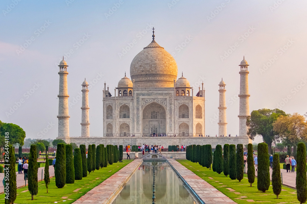 Fototapeta premium Taj Mahal front view reflected on the reflection pool, an ivory-white marble mausoleum on the south bank of the Yamuna river in Agra, Uttar Pradesh, India. One of the seven wonders of the world.