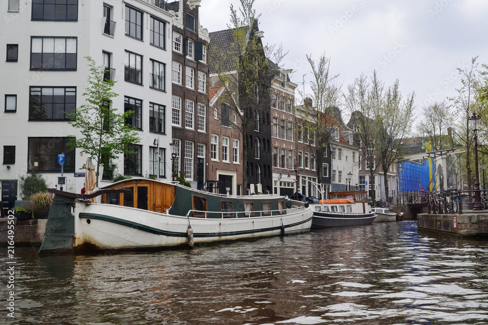 The canal of the river in Amsterdam, view from the water to the houses and the streets