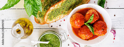 Meatballs in tomato sauce and toast with basil pesto. Dinner. Tasty food. Top view. Flat lay. Banner