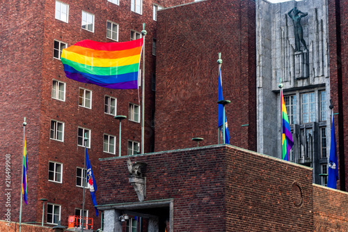 Photography A an old building in the city of Oslo with rainbow pride flags on top