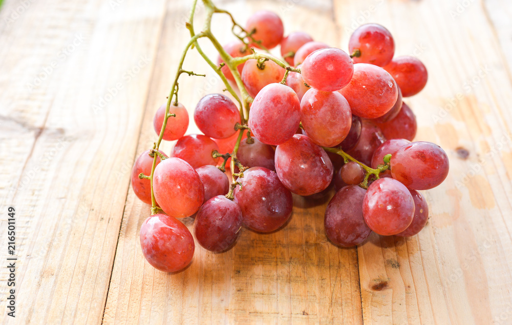 red grapes on wooden table. selective focus. red grapes on wooden table. selective focus.