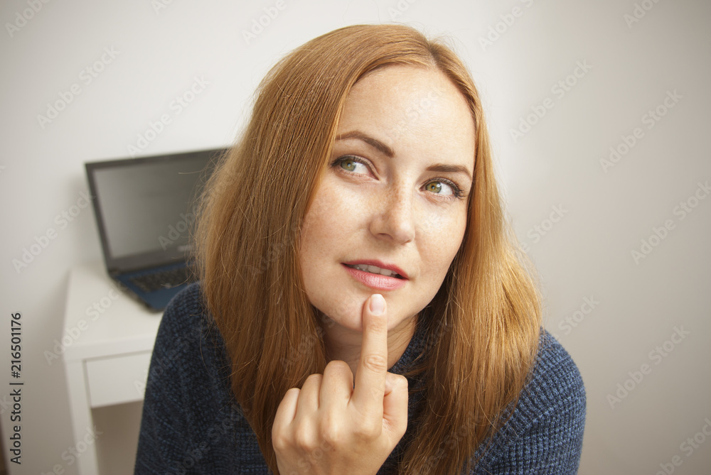 Thoughtful young freelance girl woman isolated works at home. Wearing blue sweater. Freelance at her work place. Internet and communication. Thoughtful young freelance girl woman isolated works at home. Wearing blue sweater. Freelance at her work place. Internet and communication.