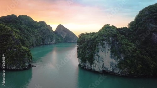 Aerial moving out shot at Halong Bay, Vietnam with limestone pillars photo