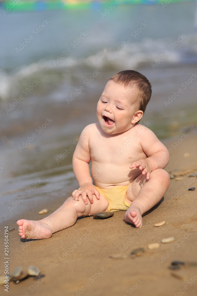 Baby playing on the sandy beach Baby playing on the sandy beach