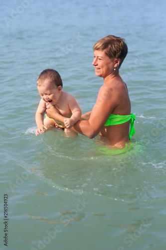 Mom with a baby on the sea © Evgenia Tiplyashina