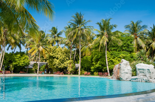 Prefect place for escape. Vacation in the tropical paradise. Green palms and turquoise water. Pool area.