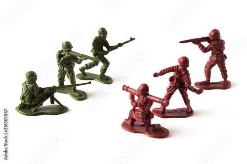 A war battle of toy soldiers, isolated on white background photo