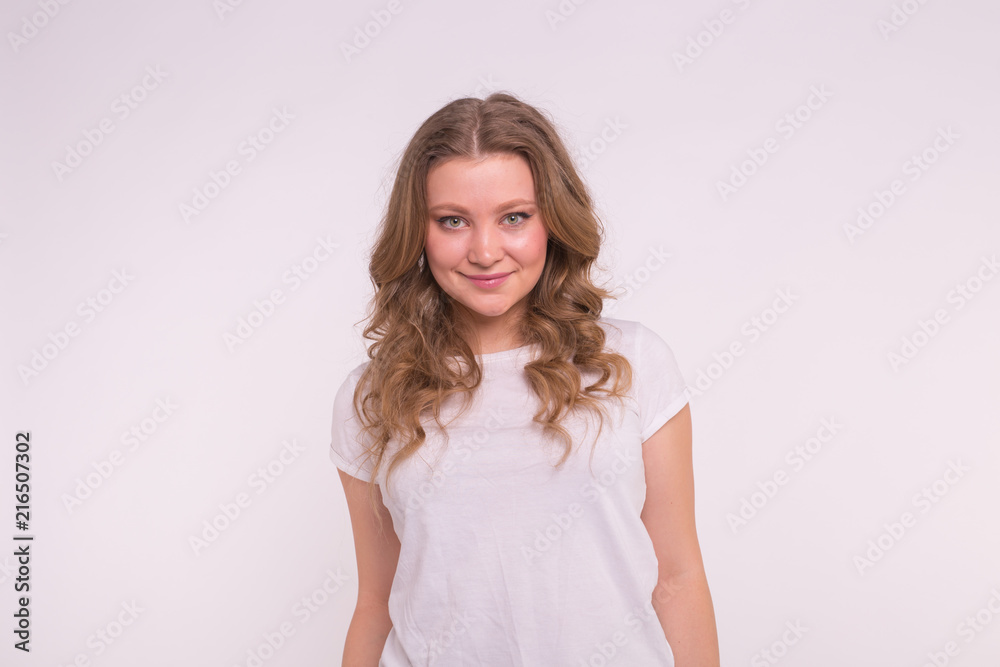 Fashion, style and people concept - pretty young woman dressed in white shirt over white background Fashion, style and people concept - pretty young woman dressed in white shirt over white background