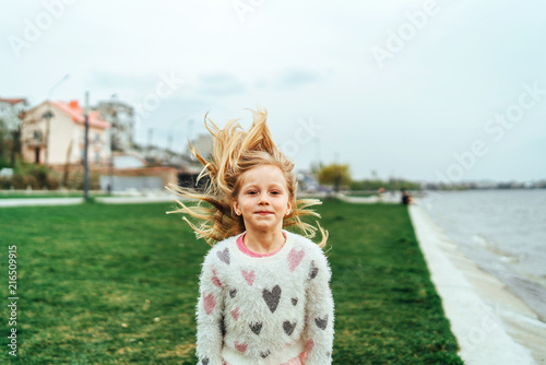 Little happy pretty girl have fun in the park