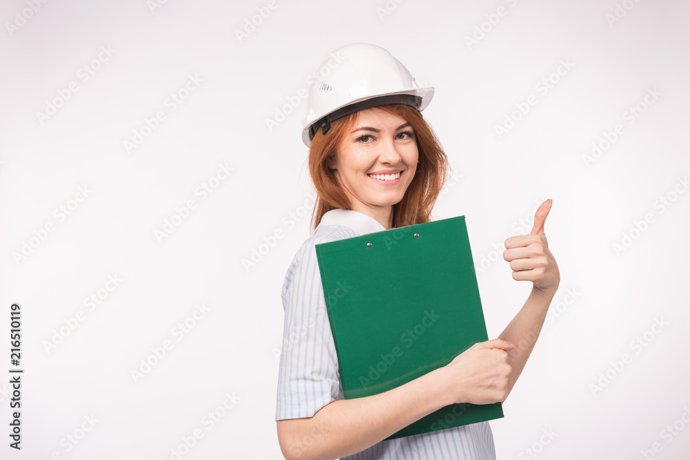 Architect, worker and realtor concept - woman builder or engineer showing thumb up on white background with copy space Architect, worker and realtor concept - woman builder or engineer showing thumb up on white background with copy space