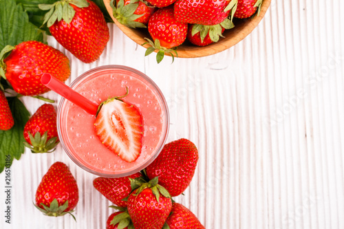 fresh strawberrysmoothie or milkshake on a wooden rustic background photo